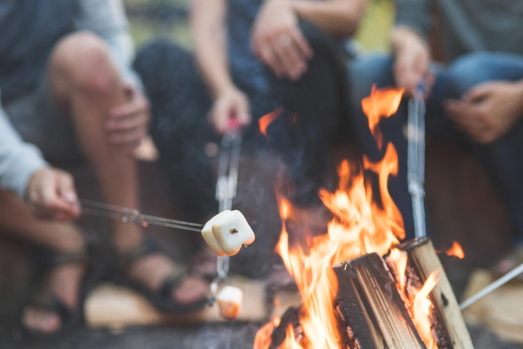 toasting marshmallows around the campfire during glamping holiday in Devon