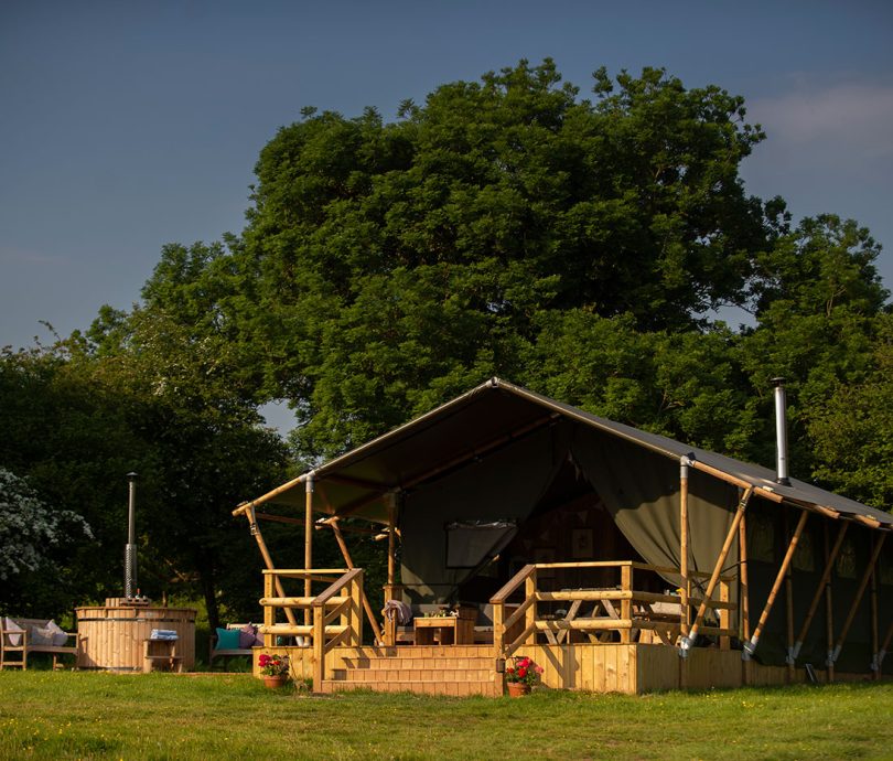 Outside a Glamping safari tent with hot tub in Devon