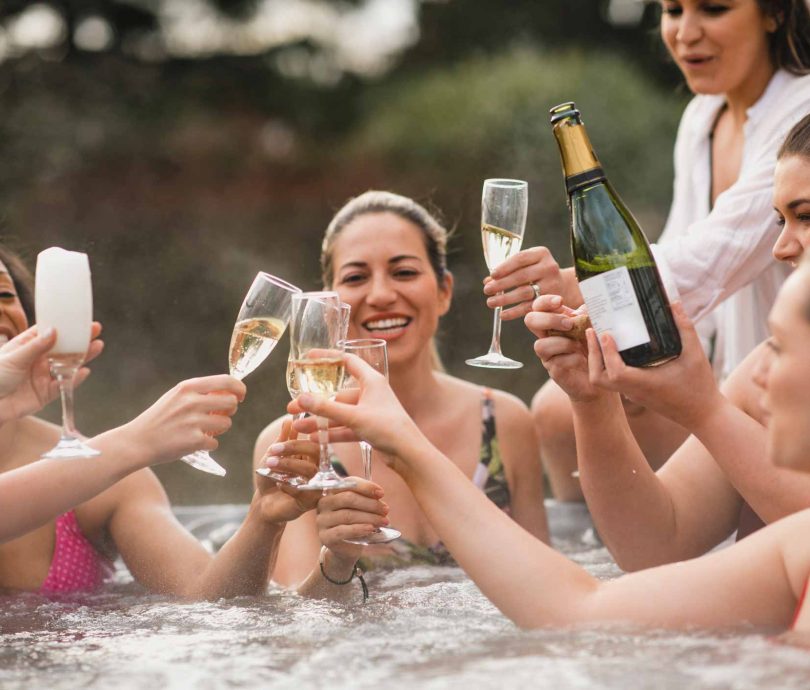 group of girls in a hot tub on a glamping hen do in Devon